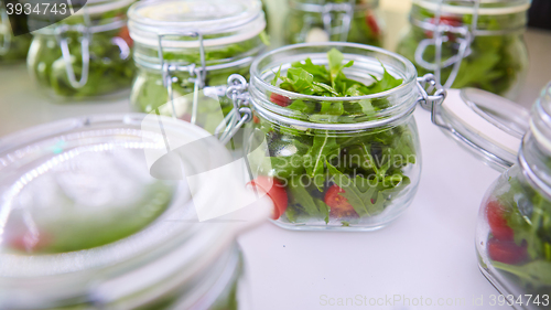 Image of vegetable salad in glass jar on white background