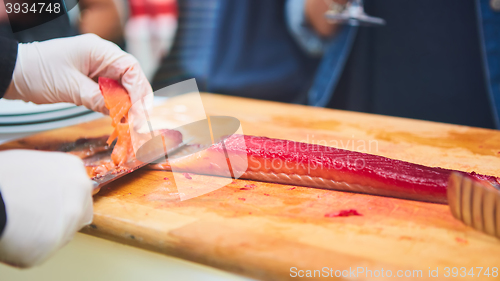 Image of chef cutting smoke salmon prepare for customer appetizer