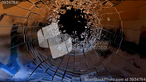 Image of Bullet hole: pieces of shattered glass