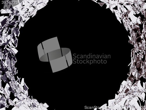Image of Big bullet hole and shattered glass on black