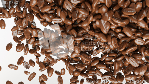 Image of flying and mixing roasted coffee beans isolated