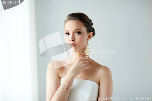 Image of beautiful asian woman with earrings and bracelet