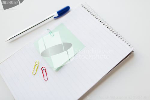 Image of close up of notebook with pen and bank paper