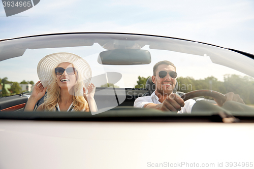 Image of happy man and woman driving in cabriolet car