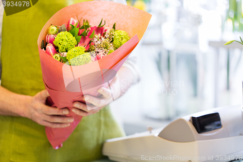 Image of close up of florist with bunch at flower shop