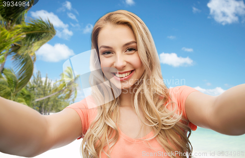 Image of happy smiling young woman taking selfie