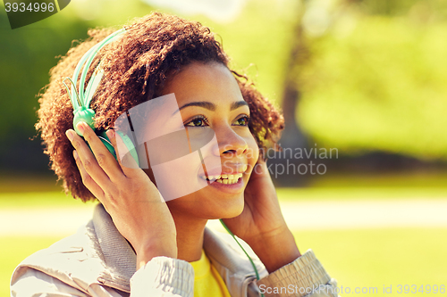 Image of african woman in headphones listening to music