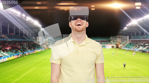 Image of man in virtual reality headset over football field