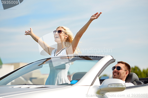 Image of happy man and woman driving in cabriolet car