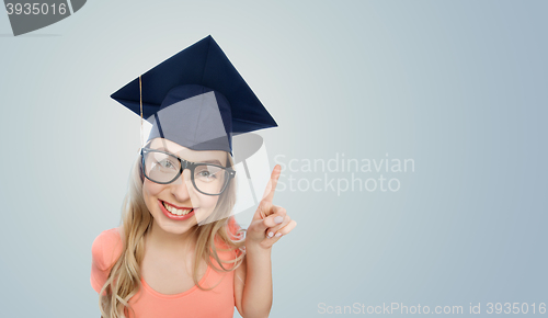 Image of smiling young student woman in mortarboard