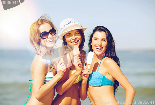 Image of girls in bikini with ice cream on the beach