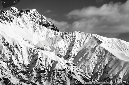 Image of Black and white snowy sunlight mountains at nice day