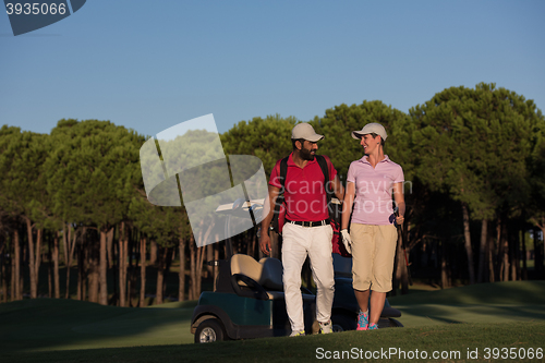 Image of couple walking on golf course