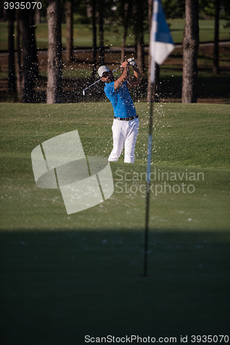 Image of pro golfer hitting a sand bunker shot