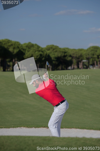 Image of golfer hitting a sand bunker shot