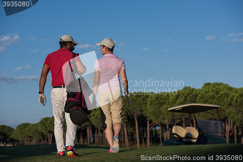 Image of couple walking on golf course