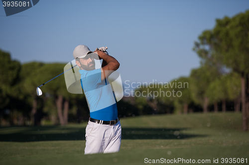 Image of pro golfer hitting a sand bunker shot