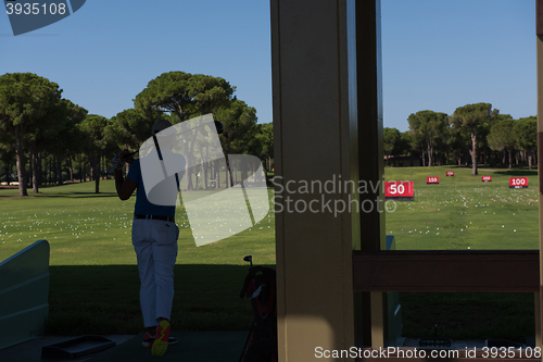 Image of golf player practicing shot on training