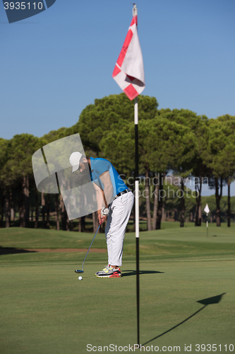Image of golf player hitting shot at sunny day