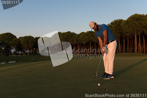 Image of golfer  hitting shot at golf course