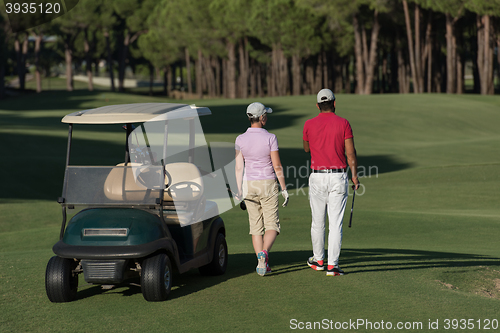 Image of couple walking on golf course