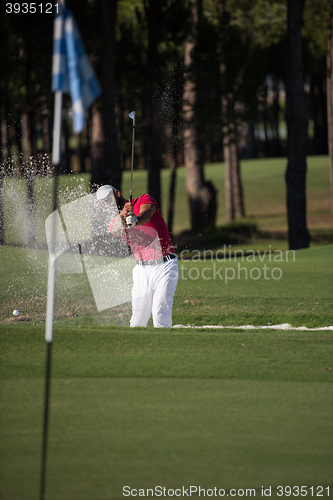 Image of golfer hitting a sand bunker shot