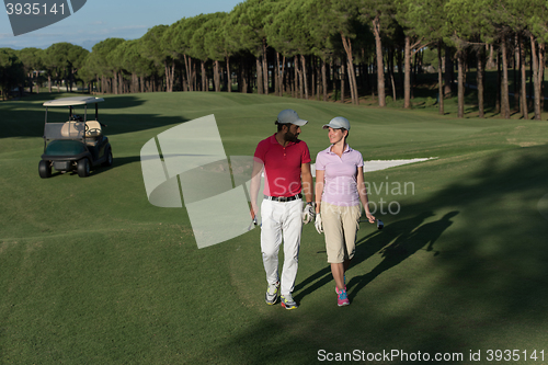 Image of couple walking on golf course