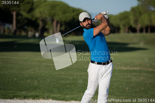 Image of pro golfer hitting a sand bunker shot