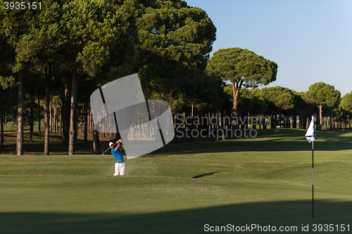 Image of pro golfer hitting a sand bunker shot