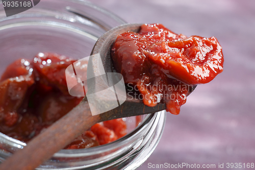 Image of Plum jam on a wooden spoon