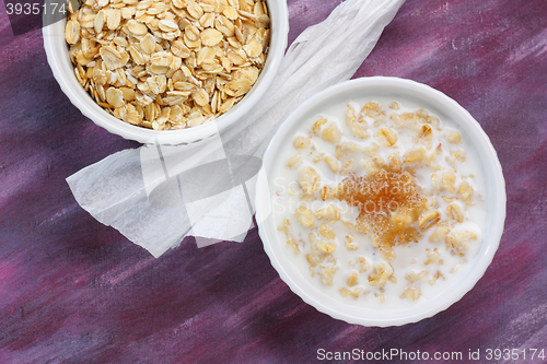 Image of Porridge with milk and brown sugar and raw rolled oats