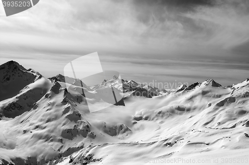 Image of Black and white snowy mountains in evening