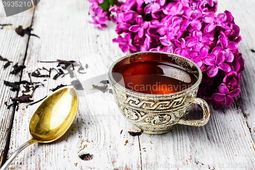 Image of Still life with tea and branch of lilac