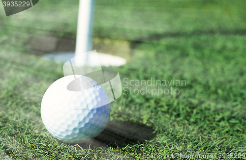 Image of Golfball in front of the hole