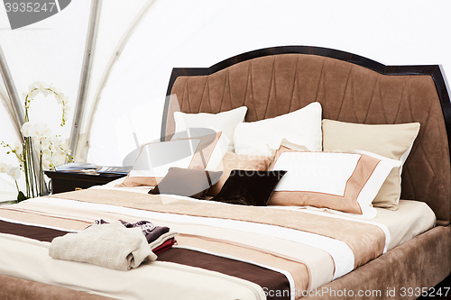 Image of Interior of a bedroom in brown tones.