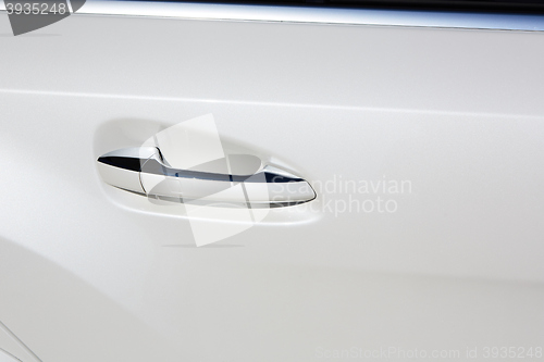 Image of white car door handle