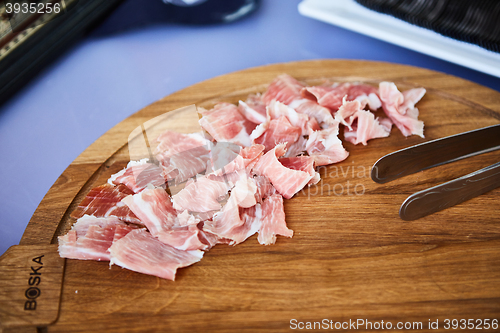 Image of sliced prosciutto on a wooden board