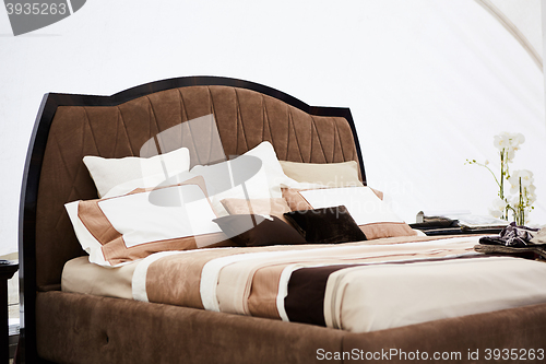 Image of Interior of a bedroom in brown tones.