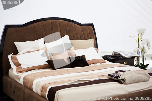 Image of Interior of a bedroom in brown tones.