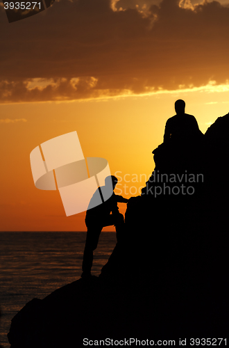 Image of Two silhouette of people in beautiful sunset 