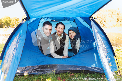 Image of happy family with tent at camp site