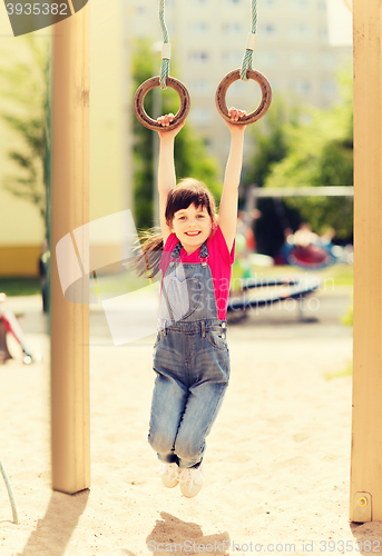 Image of happy little girl on children playground