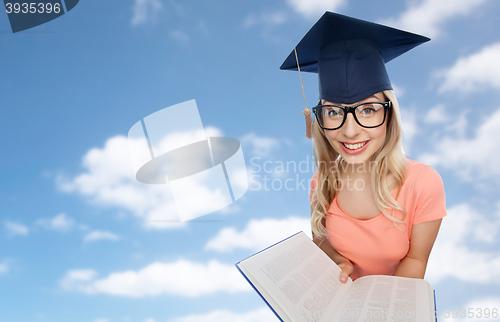 Image of student woman in mortarboard with encyclopedia