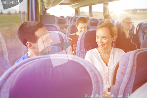 Image of group of happy passengers in travel bus