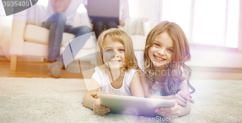 Image of happy little girls with tablet pc computer at home