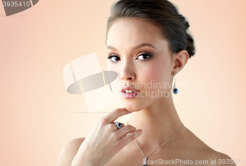 Image of beautiful woman with earring, ring and pendant