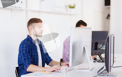 Image of creative man or student with computer at office