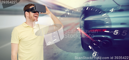 Image of man in virtual reality headset and car racing game