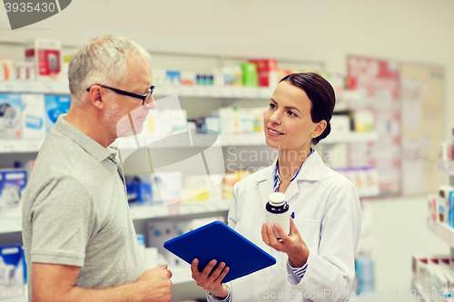 Image of pharmacist with tablet pc and senior man