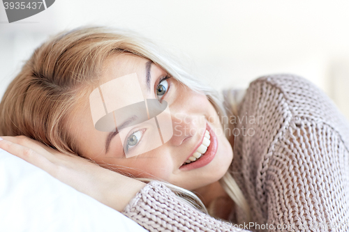 Image of young woman or teen girl lying on pillow at home